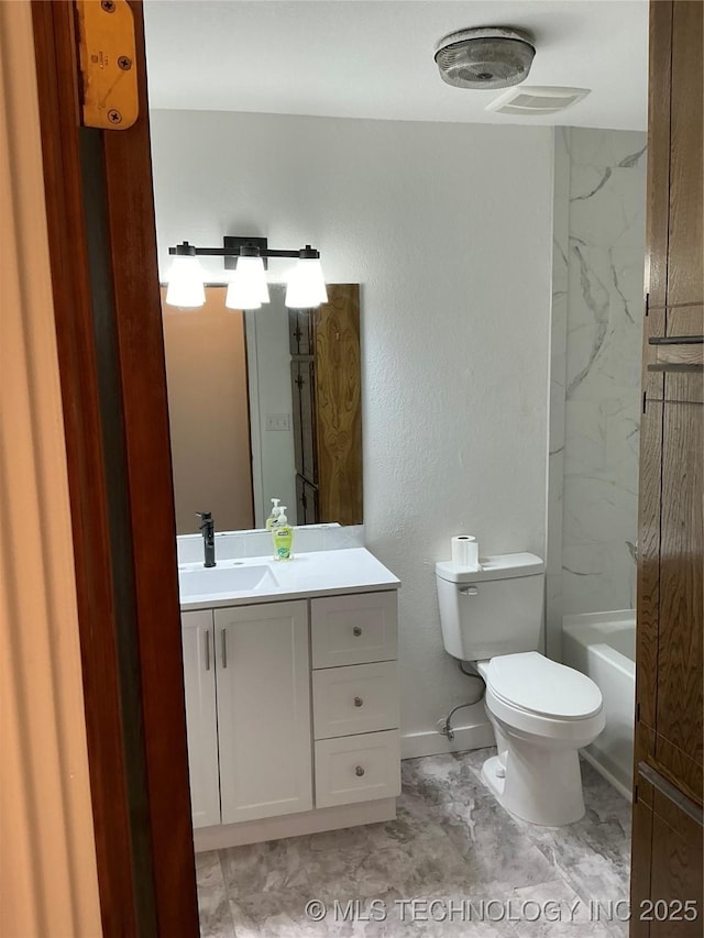 full bathroom with toilet and vanity