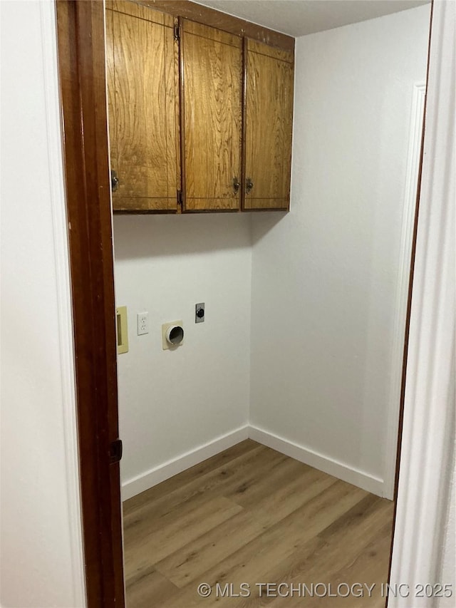 laundry room featuring hookup for an electric dryer, washer hookup, baseboards, cabinet space, and light wood finished floors