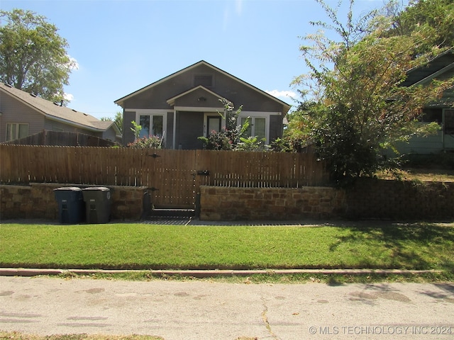 back of property with a lawn