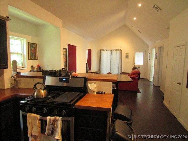 kitchen featuring lofted ceiling, dark hardwood / wood-style floors, and gas range