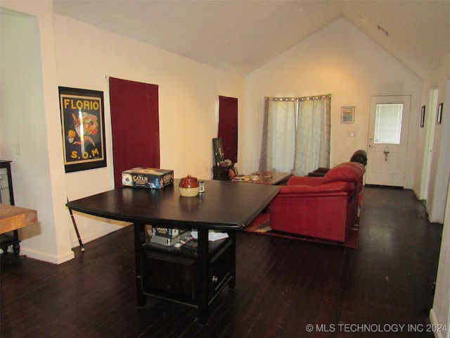 dining room with vaulted ceiling and dark hardwood / wood-style flooring