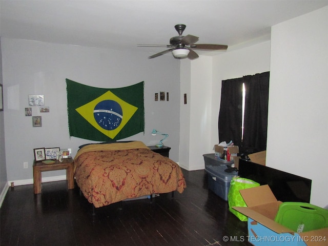 bedroom with ceiling fan and dark wood-type flooring