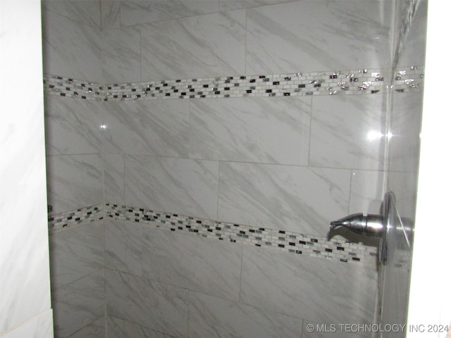 bathroom with tiled shower