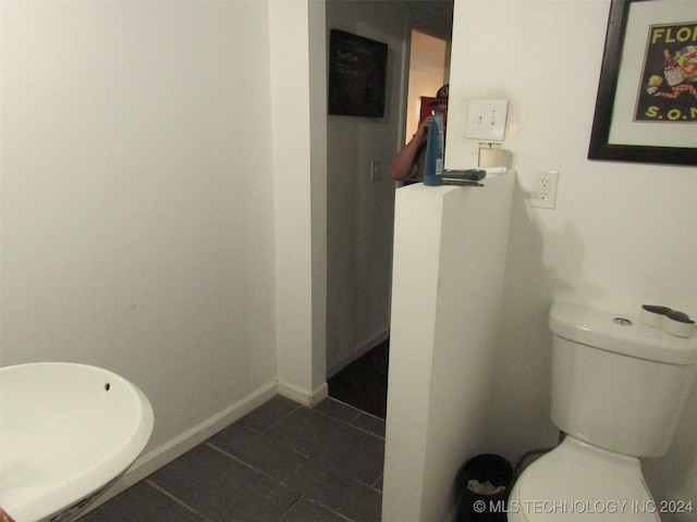 bathroom with toilet and tile patterned floors