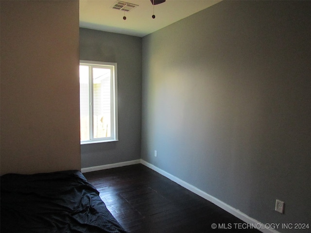 interior space with dark hardwood / wood-style floors and ceiling fan