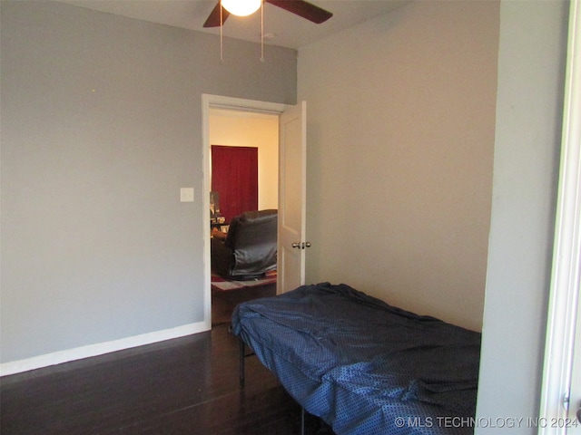 bedroom with ceiling fan and dark wood-type flooring