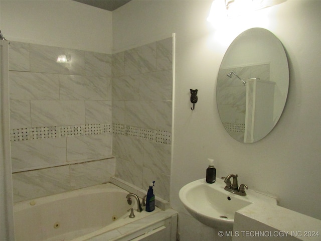 bathroom with tiled shower / bath combo and sink