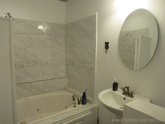 bathroom featuring tiled shower / bath and sink