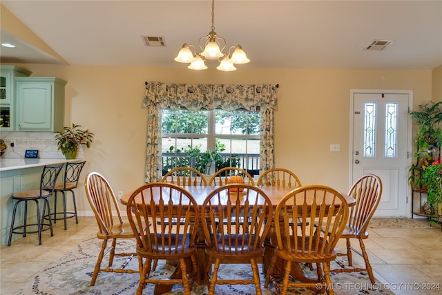 dining area with light tile patterned floors and a chandelier