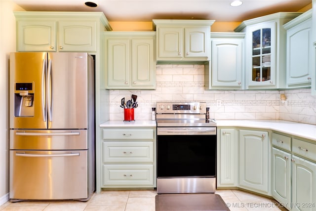 kitchen with appliances with stainless steel finishes, decorative backsplash, and light tile patterned floors