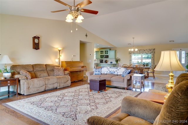 living room featuring ceiling fan with notable chandelier, lofted ceiling, and hardwood / wood-style floors