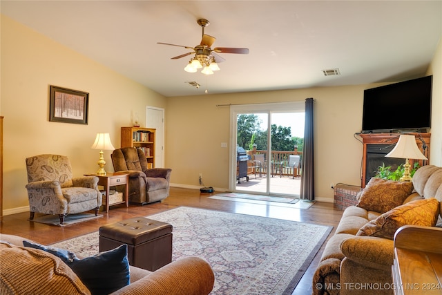 living room featuring ceiling fan and hardwood / wood-style flooring