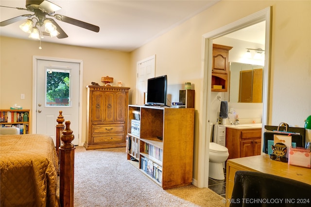 carpeted bedroom with ceiling fan and connected bathroom