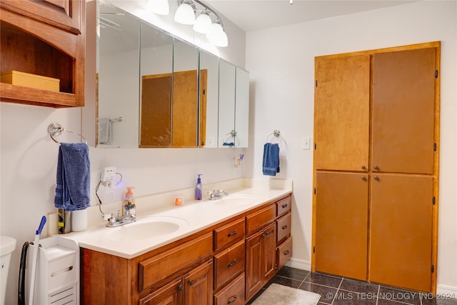 bathroom with vanity, toilet, and tile patterned floors