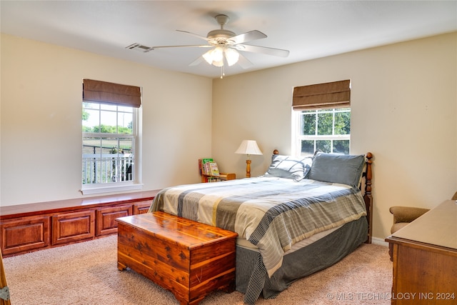 bedroom with light carpet and ceiling fan