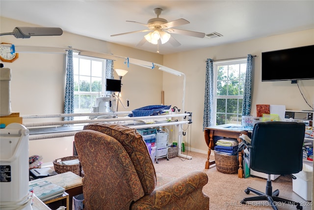 office area featuring light carpet and ceiling fan