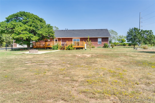 view of front of house with a wooden deck and a front yard