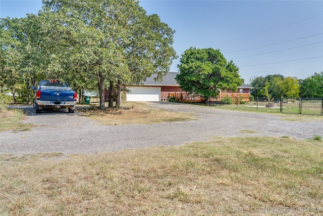 view of front of home featuring a garage and a front lawn