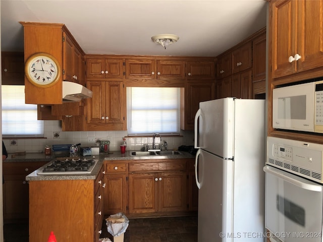 kitchen featuring ventilation hood, plenty of natural light, sink, and white appliances