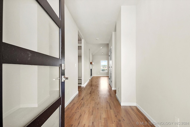 hall with light hardwood / wood-style floors