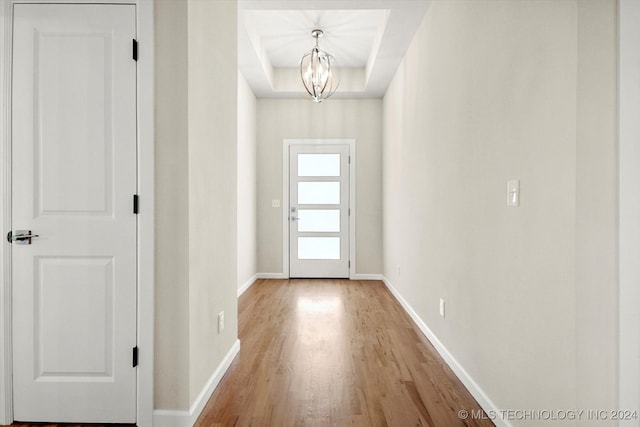 entryway featuring light hardwood / wood-style flooring and a chandelier