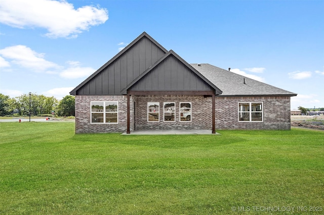 27915 E 109th Pl S, Coweta, OK 74429 - rear view of house featuring board and batten siding, brick siding, a patio, and a lawn