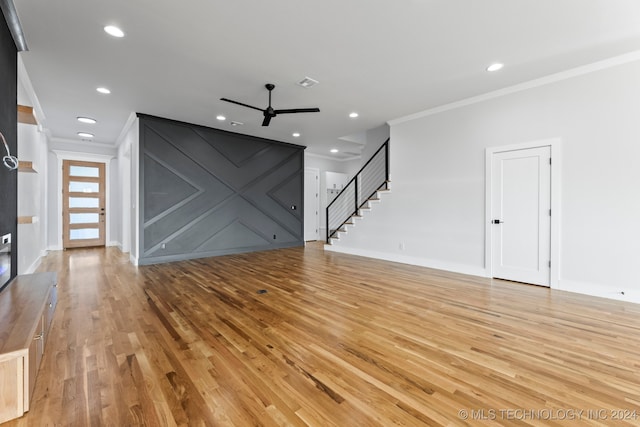 unfurnished living room with light wood-type flooring, ornamental molding, and ceiling fan