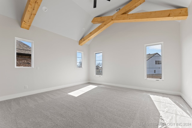 carpeted spare room featuring beamed ceiling, plenty of natural light, and high vaulted ceiling