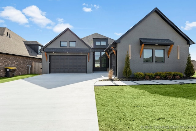 view of front of property featuring a garage and a front yard