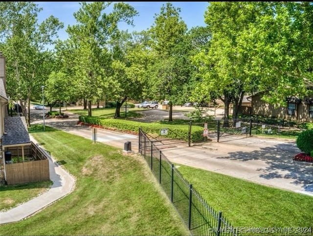 view of property's community with a lawn