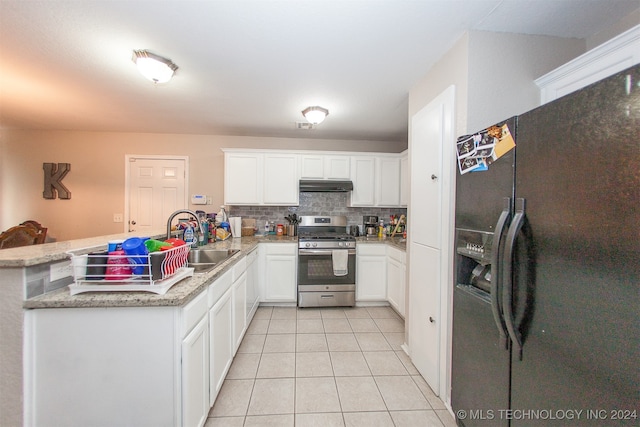 kitchen with stainless steel gas range oven, black fridge with ice dispenser, kitchen peninsula, and white cabinetry