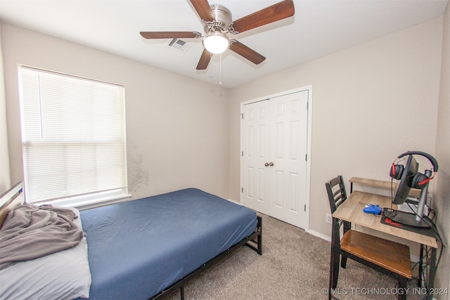 carpeted bedroom featuring a closet and ceiling fan