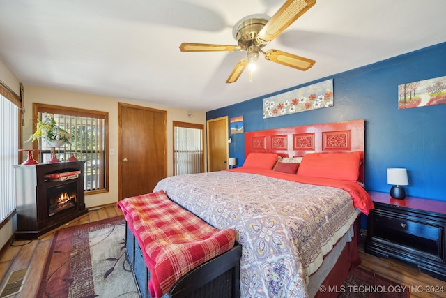 bedroom with ceiling fan and dark wood-type flooring