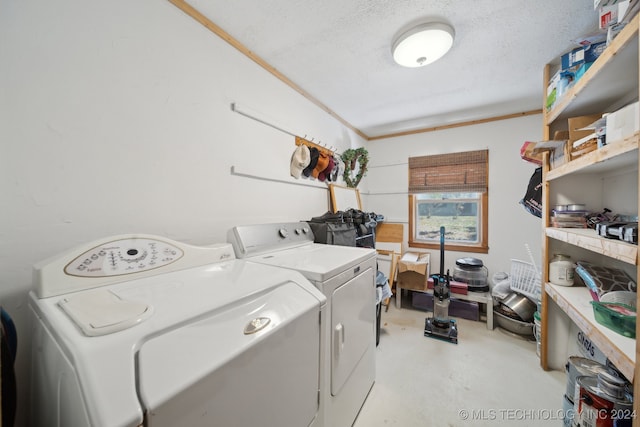 laundry area with ornamental molding, a textured ceiling, and independent washer and dryer