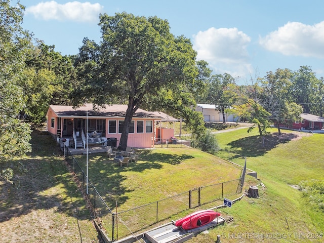 rear view of house featuring a yard