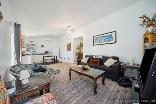 living room featuring an AC wall unit, vaulted ceiling, and carpet flooring