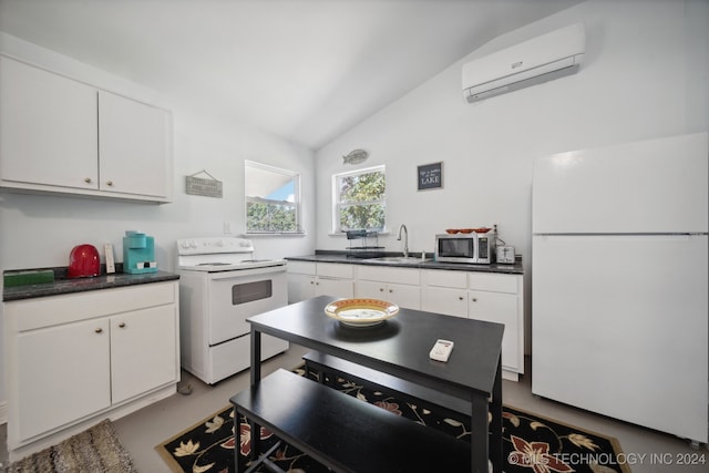 kitchen with white cabinetry, vaulted ceiling, white appliances, a wall unit AC, and sink