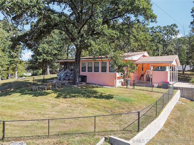 rear view of house with a yard