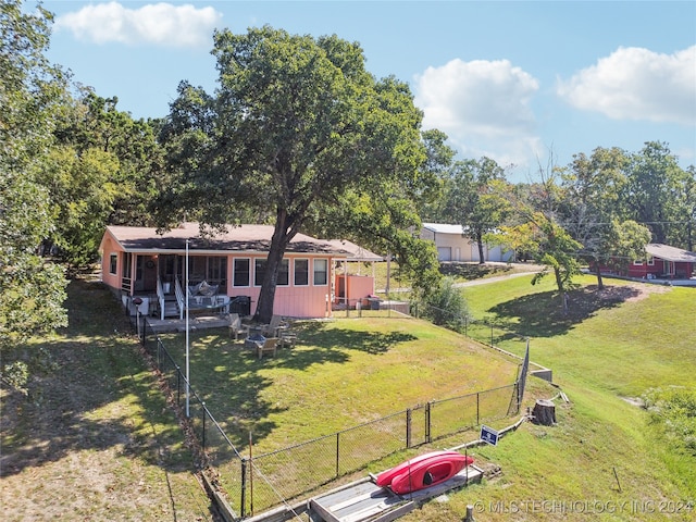 rear view of house with a yard