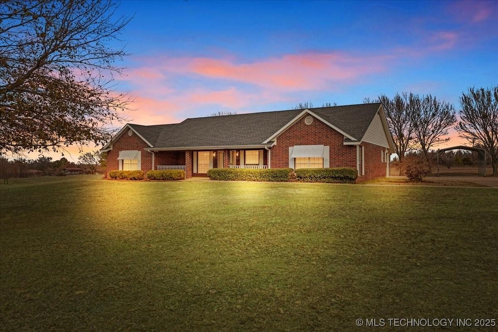 ranch-style house with a lawn