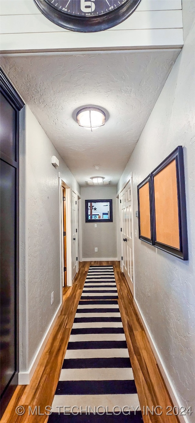 corridor with dark hardwood / wood-style floors