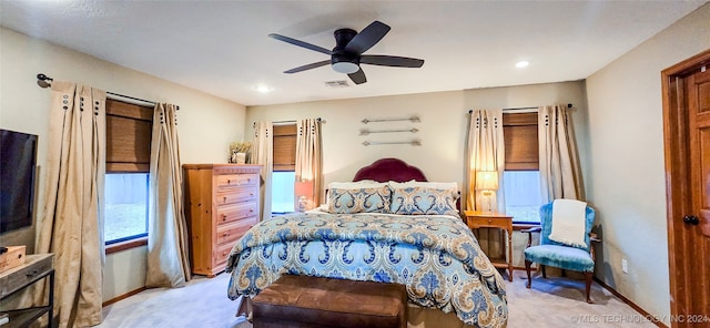 bedroom with ceiling fan and light carpet