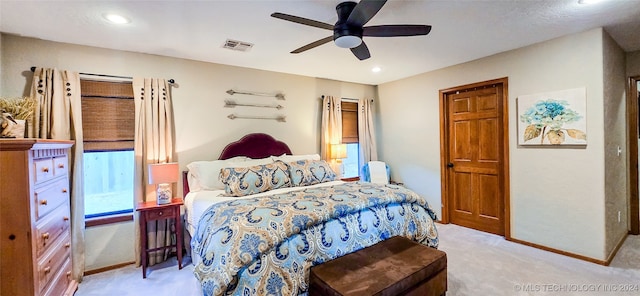 bedroom with ceiling fan and light colored carpet