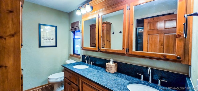 bathroom with hardwood / wood-style floors, vanity, and toilet