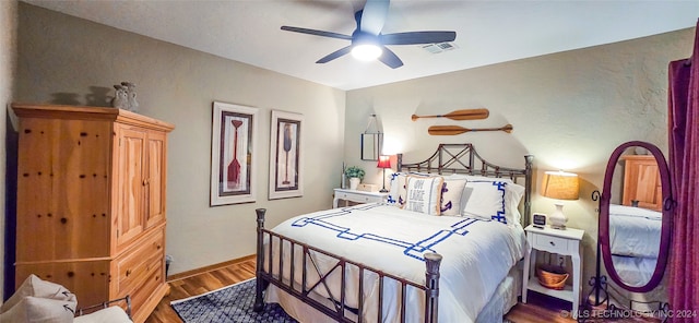 bedroom with hardwood / wood-style flooring and ceiling fan