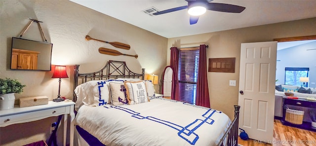 bedroom with ceiling fan and light hardwood / wood-style floors