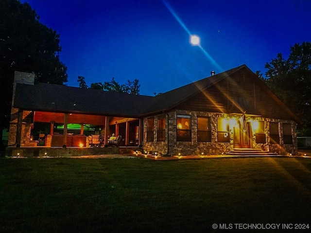 back house at night with a yard