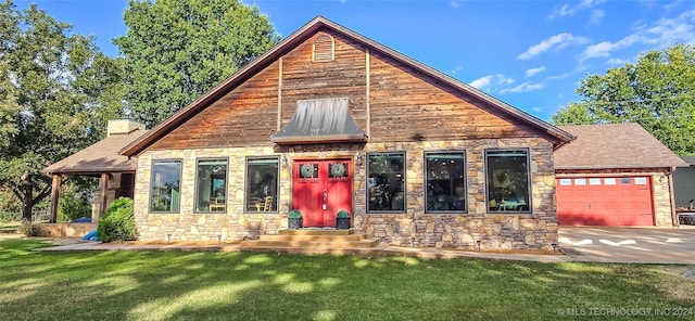 view of front of house featuring a garage and a front yard