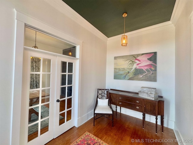 living area featuring crown molding, french doors, and hardwood / wood-style flooring