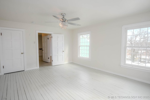 empty room with ceiling fan and light wood-type flooring